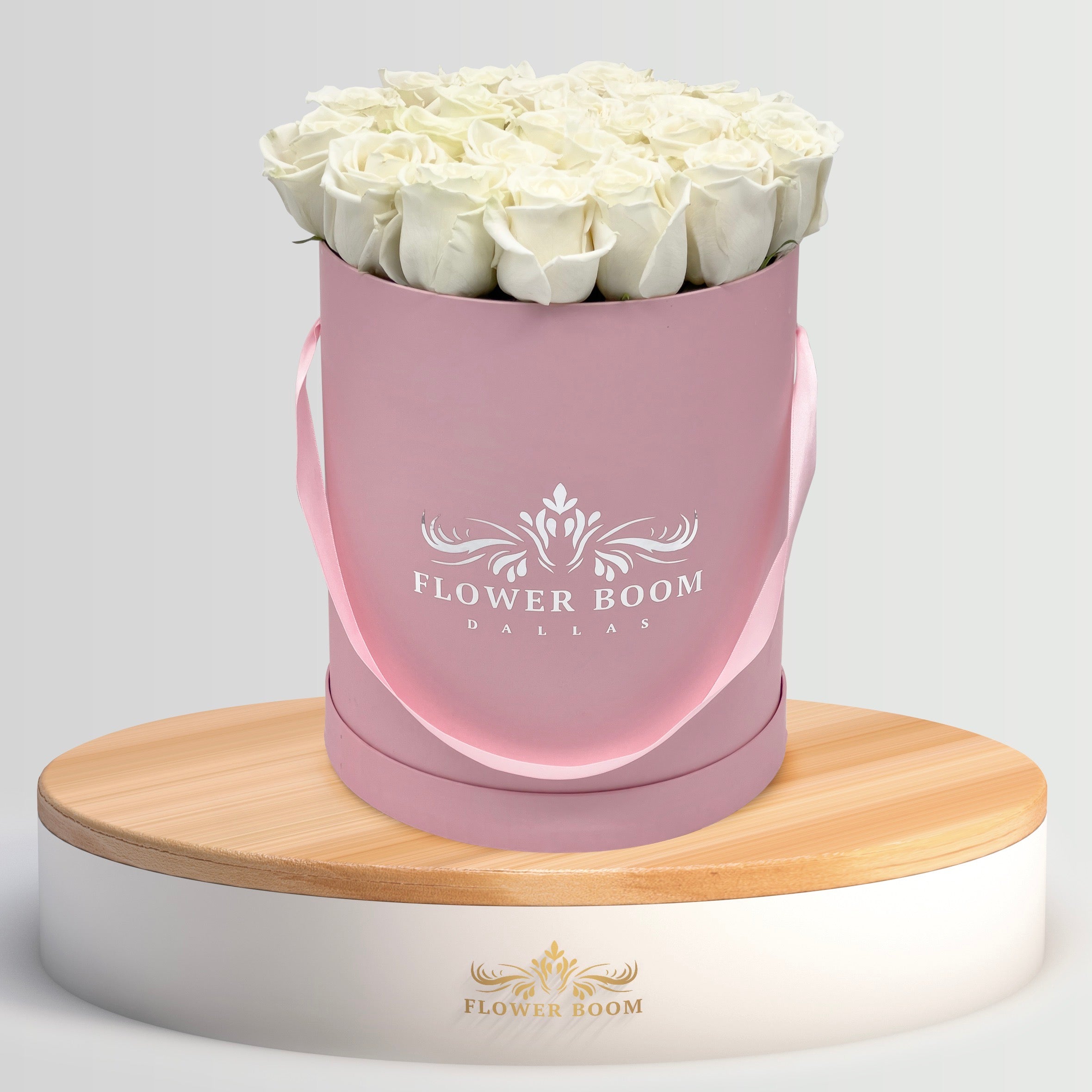 white roses in a pink box